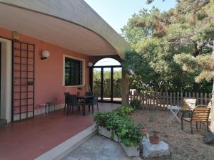 a porch of a house with a table and chairs at Casa Don Peppì in Monopoli