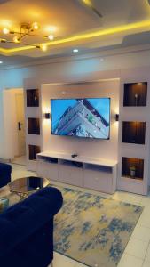 a living room with a large flat screen tv at Exquisite 2-Bedroom Apt in Oniru in Lagos
