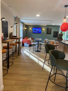 a bar with chairs and tables and a couch at Campanile Nantes ~ Rezé Aéroport in Rezé