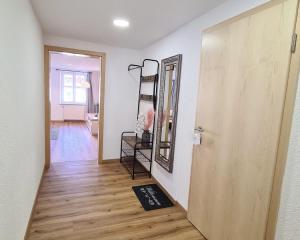 a hallway with a door and a rug on the floor at Stadtzimmer im Entenmoos in Bad Waldsee