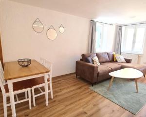 ein Wohnzimmer mit einem Sofa und einem Tisch in der Unterkunft Stadtzimmer im Entenmoos in Bad Waldsee