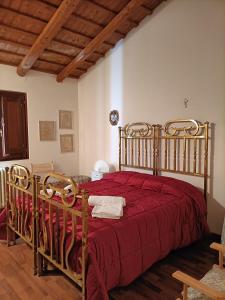 a bedroom with a large bed with a red bedspread at Aromi di casa in Pianella