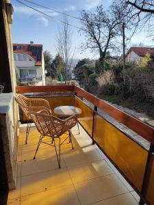 a balcony with two chairs and a table at Hillside Lodge in Budapest