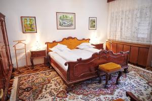 a bedroom with a large wooden bed and a table at Kormos Residence in Brăduţ +118 photos