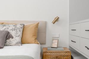 a bedroom with a bed and a nightstand with a laptop on it at Luxury flat Atocha I in Madrid