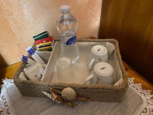 a basket with a bottle of water and other items at Bed and Breakfast Li Paduli Alvi in Cannigione