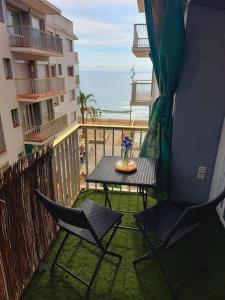 a balcony with a table and chairs on a balcony with the ocean at CalafellBeach.SeaViews,New in Calafell