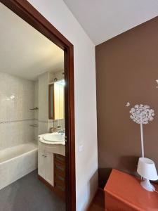 a bathroom with a tub and a sink and a mirror at Allotjament Sanuy a Tremp in Tremp +17 photos