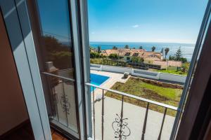 a view of the ocean from a balcony at Tranquilidade in Estreito da Calheta