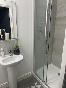 a bathroom with a shower and a sink at Seadream Luxury Hot Tub Holiday Home Homesweetholidayhomes in Scarborough +29 photos
