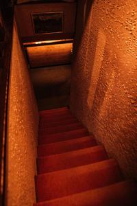a stairway with red stairs in a building at 歩絵夢の森 Pension Poem no mori in Hakuba
