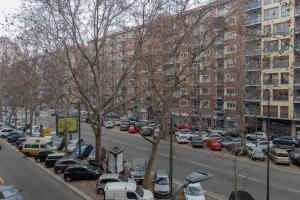 a city street with cars parked in a parking lot at Suite Campania - ristrutturato nuovo vicino M4 in Milan