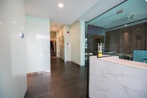 a bathroom with a marble counter and a mirror at Chill Suites Kuala Lumpur in Kuala Lumpur