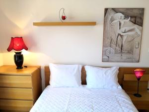 a bedroom with a bed and a painting on the wall at Orange Flat - POOL-WIFI - Portimão in Portimão