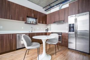 a kitchen with a table and two chairs and a refrigerator at Downtown 1BR w Gym WD walkable location SEA-48 in Seattle +10 photos