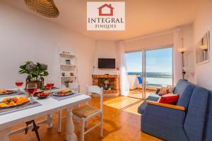 a living room with a table and a blue couch at Cala Margarida in Palamós