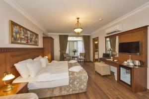 a bedroom with a bed and a desk with a television at Hotel Blisstanbul in Istanbul