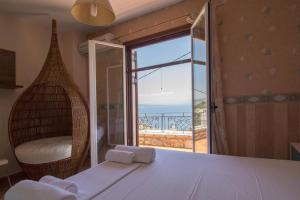 a bedroom with a bed with a view of the ocean at Malvazios Villas #4 in Gythio