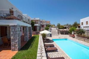 a villa with a swimming pool and a house at Malvazios Villas #4 in Gythio