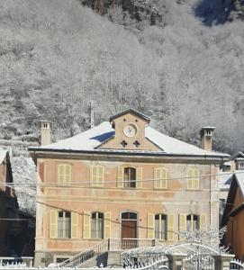 a large building with a clock on top of it at B&B VILLA ROSA in Anzino