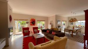 a living room with a couch and chairs and a table at Sunshine - Private Pool - 8 Guests - Albufeira in Albufeira