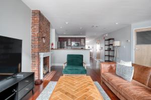 a living room with a couch and a fireplace at Downtown 1BR w WD in-unit nr TD Garden BOS-212 in Boston