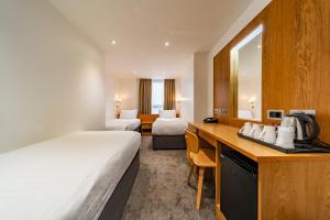 a hotel room with a bed and a desk at Central Park Hotel in London +37 photos