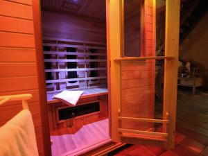 a room with a sauna in a house at Quietly located farmhouse with sauna and hot tub in Balkbrug