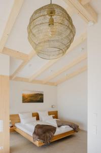 a bedroom with a large bed and a ceiling at Weinberg Chalets in Malsch