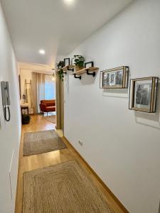 a living room with two rugs on a wall at Apartamento en palmeira - Colores del Barbanza Naranja in Ribeira