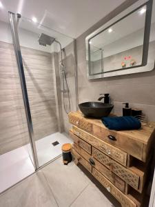 een badkamer met een wastafel en een glazen douche bij Le bonheur de saint Aygulf in Saint-Aygulf
