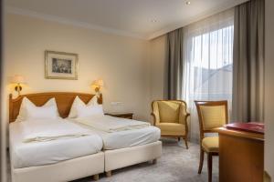 Posteľ alebo postele v izbe v ubytovaní Vergeiner's Hotel Traube