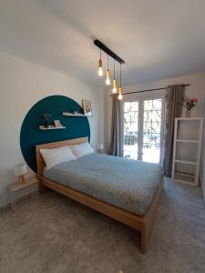 a bedroom with a large bed with a blue headboard at La Fuente in El Paso
