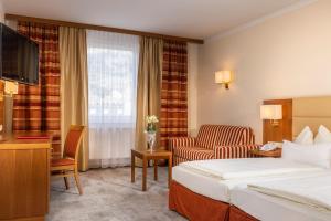 Posteľ alebo postele v izbe v ubytovaní Vergeiner's Hotel Traube
