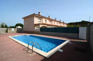 a swimming pool in front of a house at Rambla Mallols 29 in L'Escala