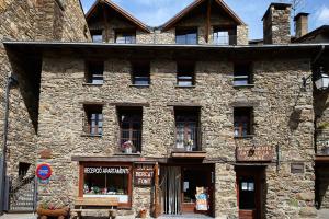 an old stone building with a store in front at Chalet Font in Soldeu