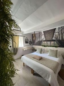 a bedroom with a large white bed in it at Hôtel Auberge Provençale in Saint-Raphaël