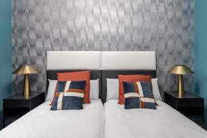 1 dormitorio con 2 camas con almohadas y 2 lámparas en Beautiful Room in Heart of Madrid, en Madrid