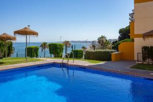 a swimming pool with a view of the ocean at Seaview terrace with pool in Carvajal Ref 103 in Torremuelle