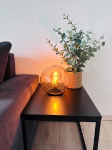 a candle on a coffee table in front of a couch at Ferienwohnung am Hengsteysee in Herdecke