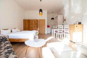 a living room with a bed and a table at Burg Rotraut #2 in Ostseebad Sellin +1 photo