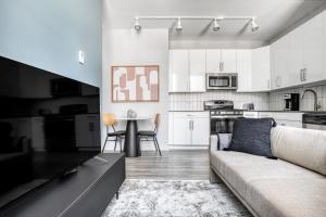 a living room with a couch and a kitchen at Loop 1BR w Gym Roof Lounge same block as L CHI-670 in Chicago