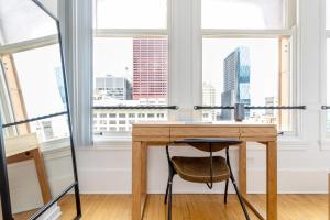 a wooden desk in a room with windows at Loop 1BR w Gym Doorman nr L Parks CHI-301 in Chicago