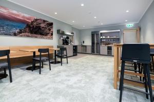 a kitchen and dining room with a table and chairs at b-smart motel Schaan in Schaan