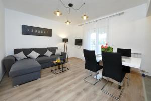 a living room with a couch and a table at Apartment Simunic Punta in Bibinje