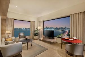 a living room with a large view of the water at Trident Nariman Point in Mumbai