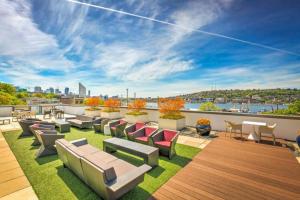 a rooftop patio with furniture and a view of the city at S Lake Union 2BR w Gym WD nr Space Needle SEA-192 in Seattle