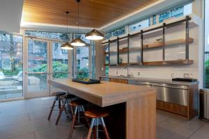a kitchen with a large island with bar stools at S Lake Union 2BR w Gym WD nr Space Needle SEA-192 in Seattle
