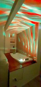 a bathroom with a tub with colorful lights on the ceiling at BARBARA Classy Apartments 103 in Siracusa