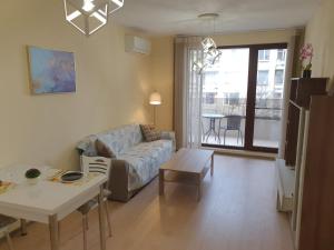 a living room with a couch and a table at Augusta Apartment in Stara Zagora